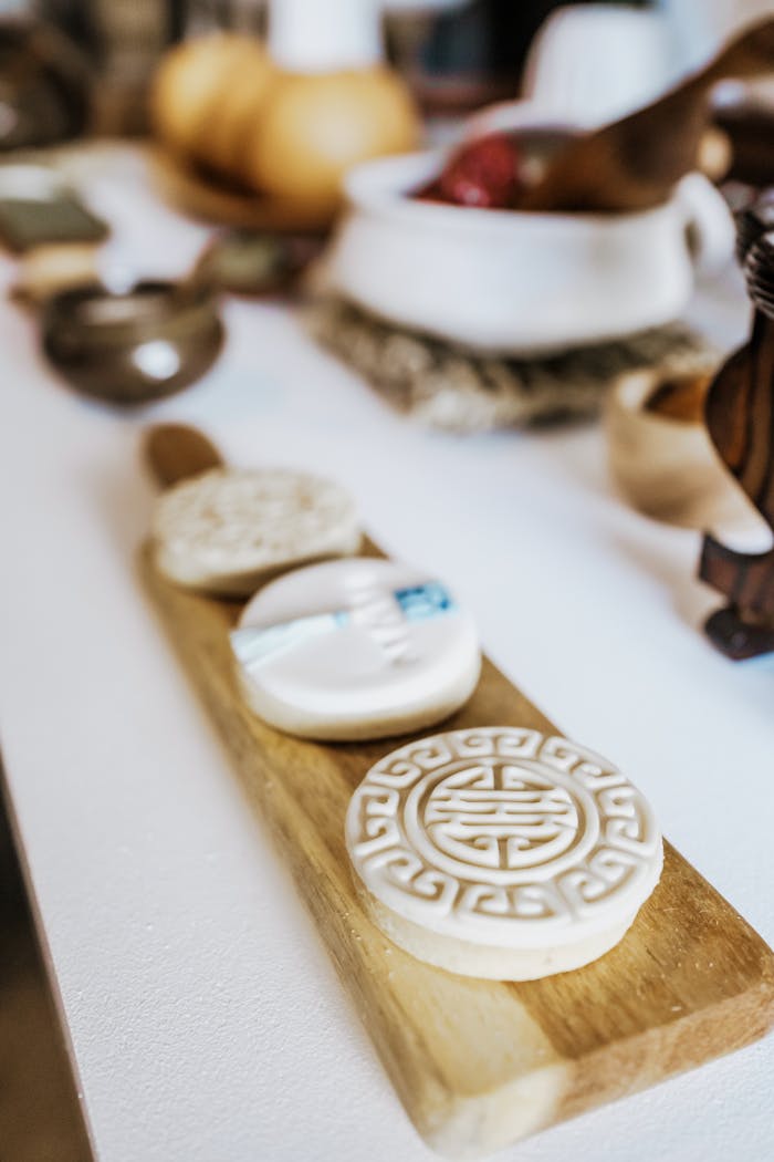 Artistic display of intricate Korean traditional mooncakes on a rustic wooden board.